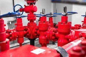 triple duty valves on a pipe system painted red