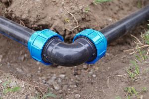 a PVC elbow fitting connecting two pieces of pipe